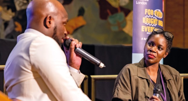 A man and a women hold a discussion at a business event