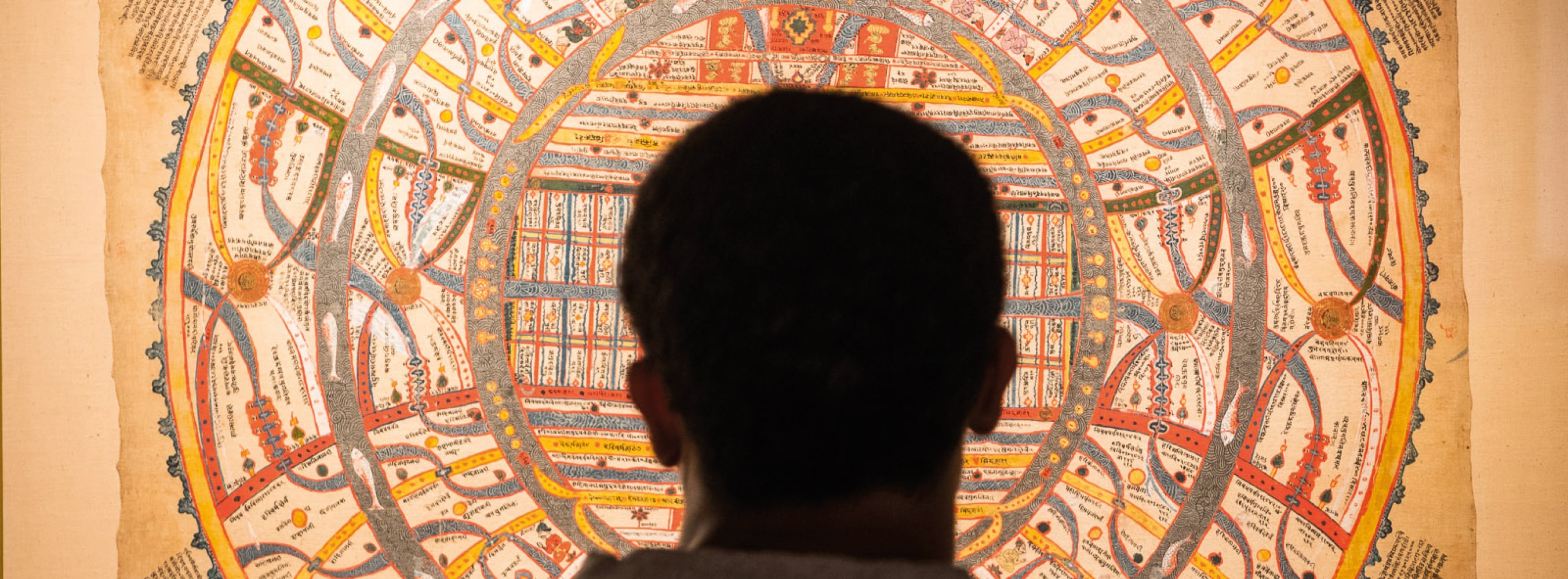 A silhouette of a man's head in front of a manuscript at the British Library