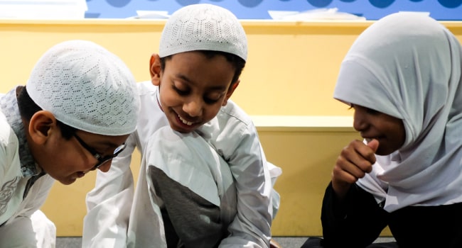 Three young children play at a British Library event