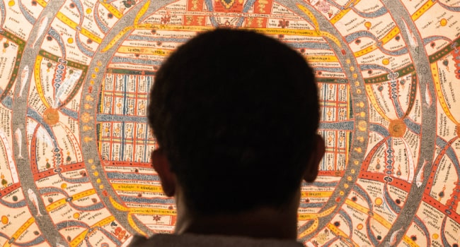 A silhouette of a man’s head in front of a manuscript at the British Library