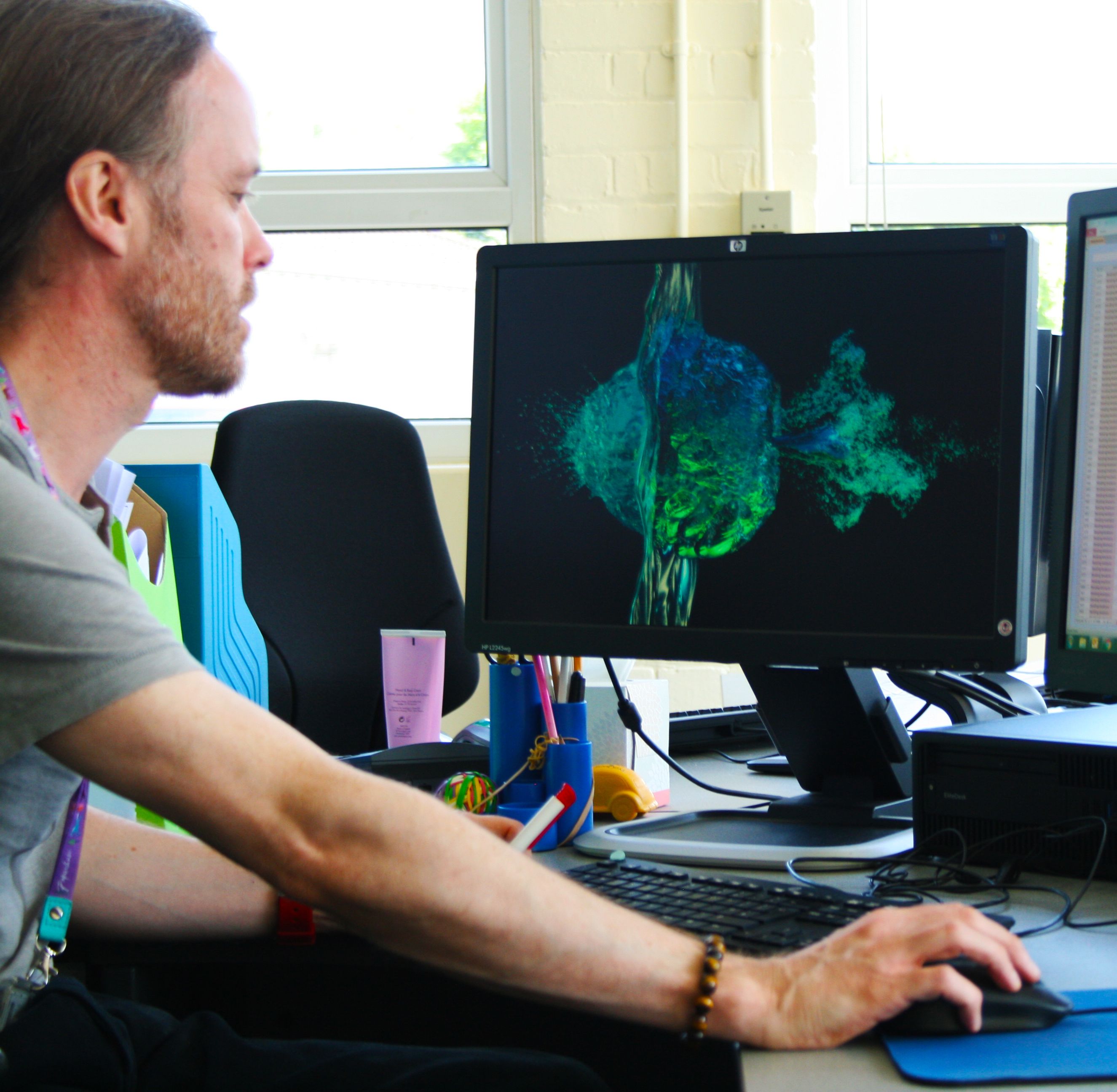 Man looking at computer screens.