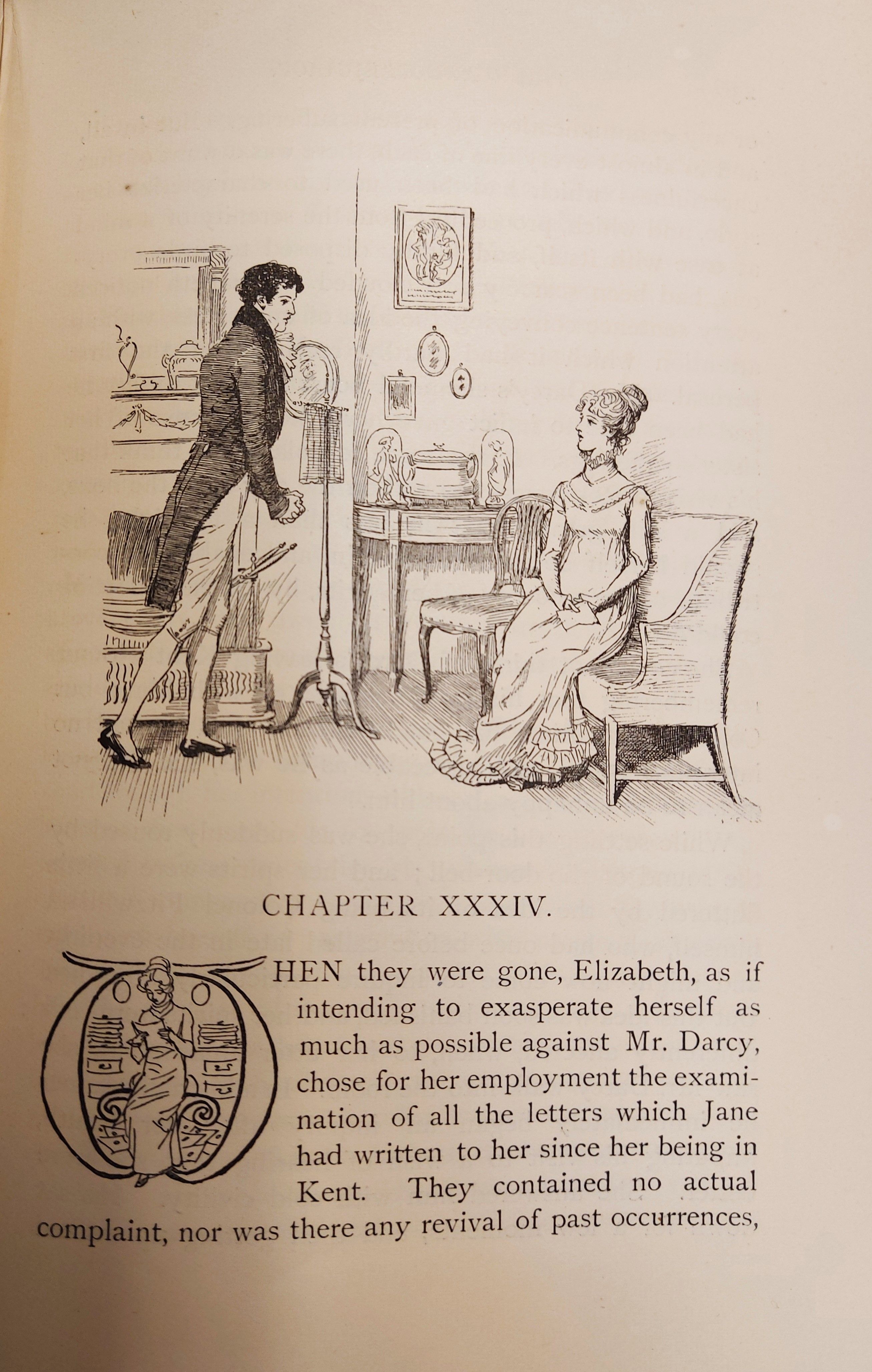 The beginning of Chapter 34 of Pride and Prejudice, from George Allen's 1894 illustrated edition of the novel. The page features a headpiece illustration by Hugh Thomson, depicting a scene from the chapter. In the illustration, Elizabeth is sitting on a couch and Mr Darcy is standing by a fireplace. The page also features an ornamental initial letter W, within which is drawn Elizabeth reading a letter.