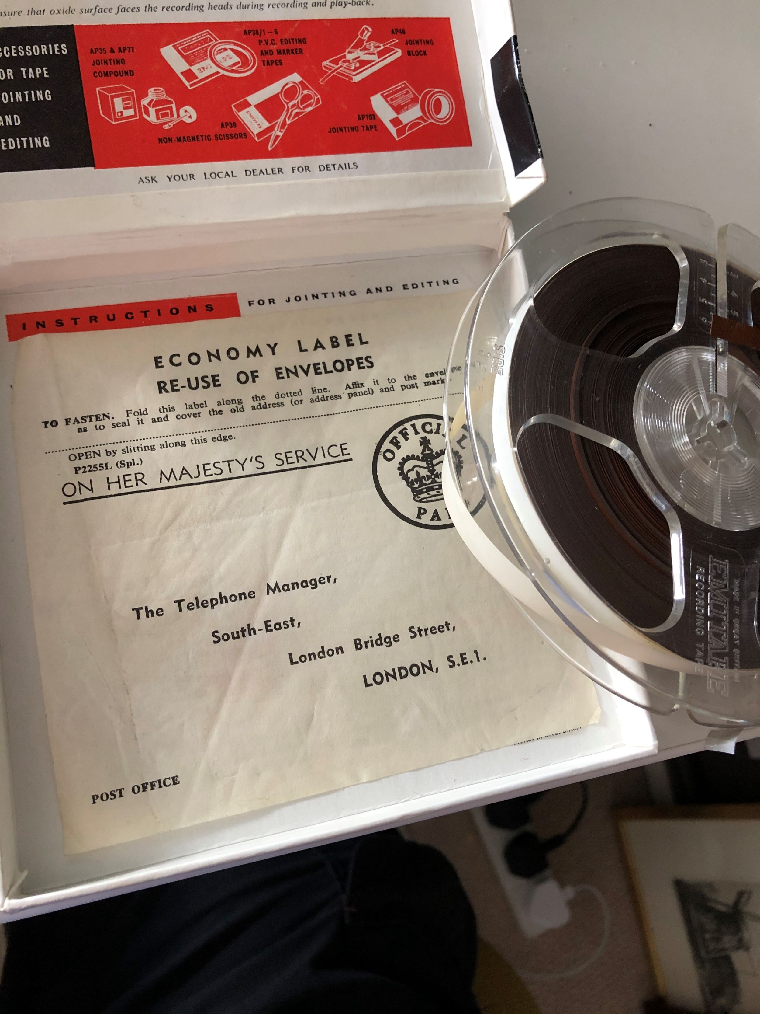 A recording reel and its case.