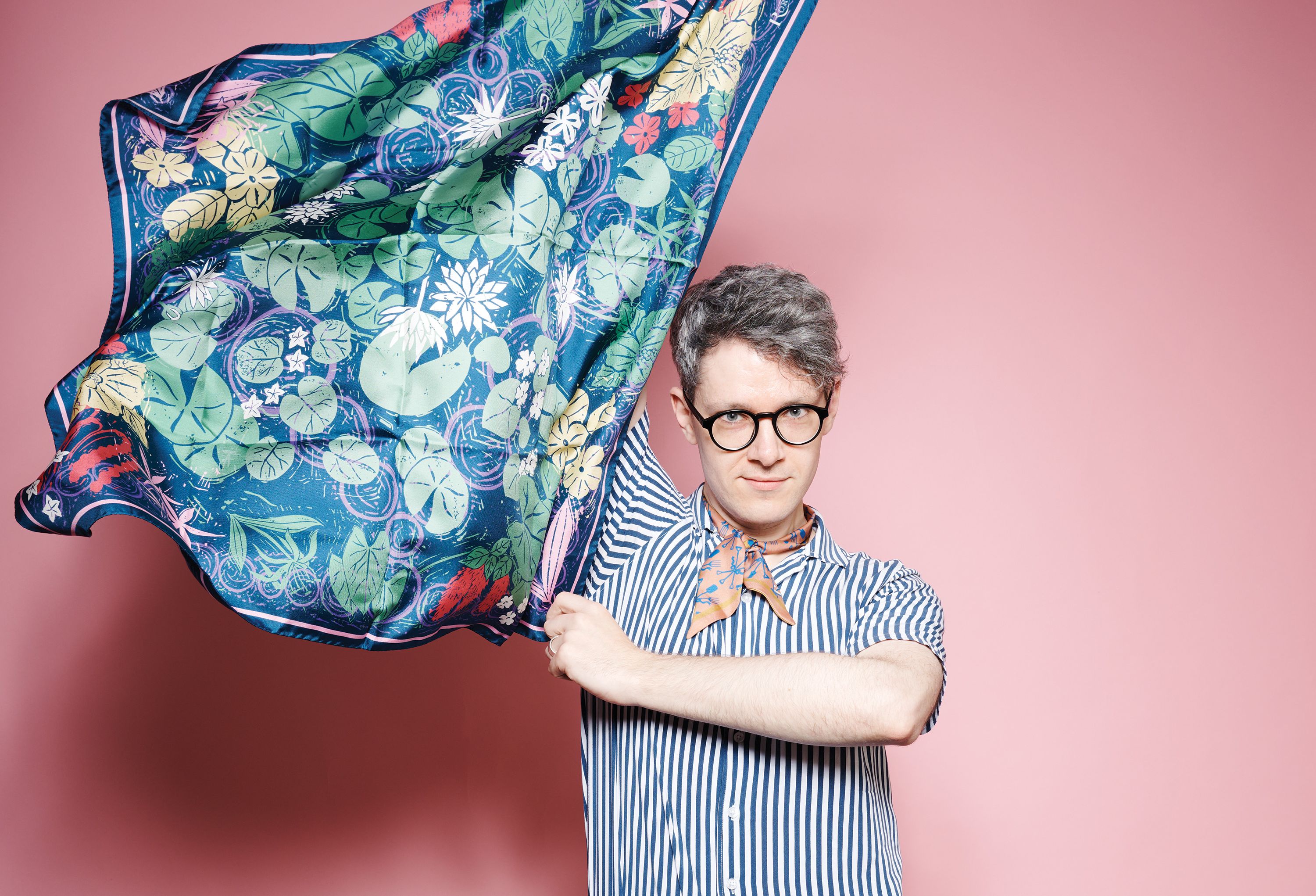 Man holding up fabric.