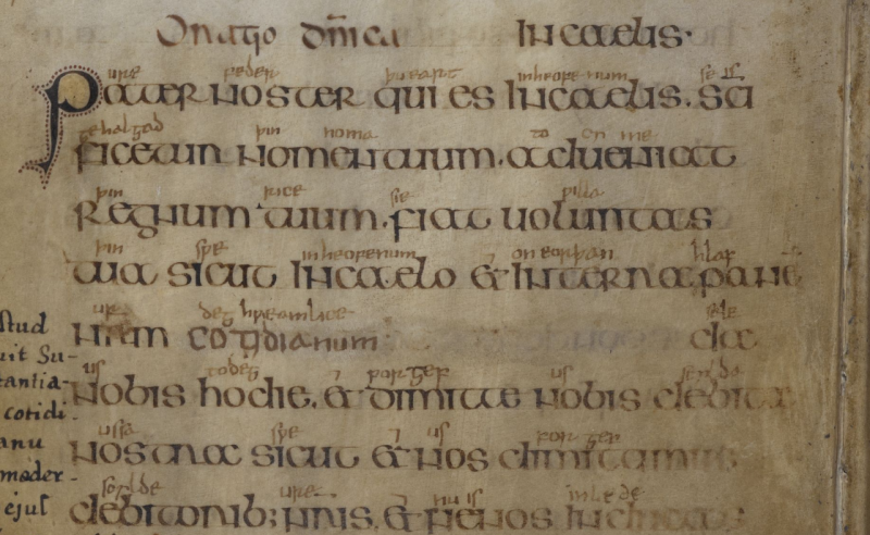 Detail of manuscript page. Handwriting in black with smaller writing in dark brown above some of the words