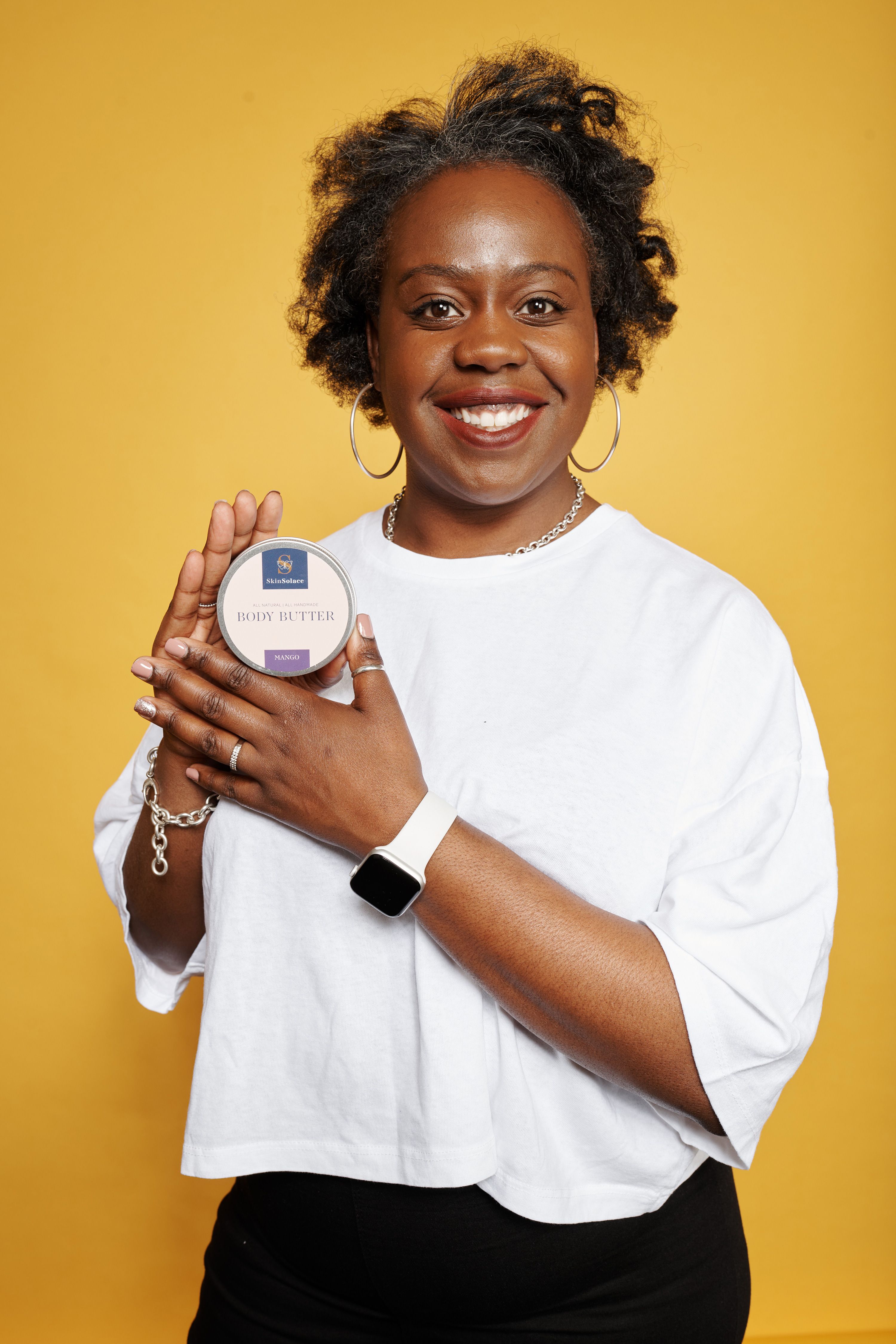 Natalee Onyeche holding a tub of Skin Solace.