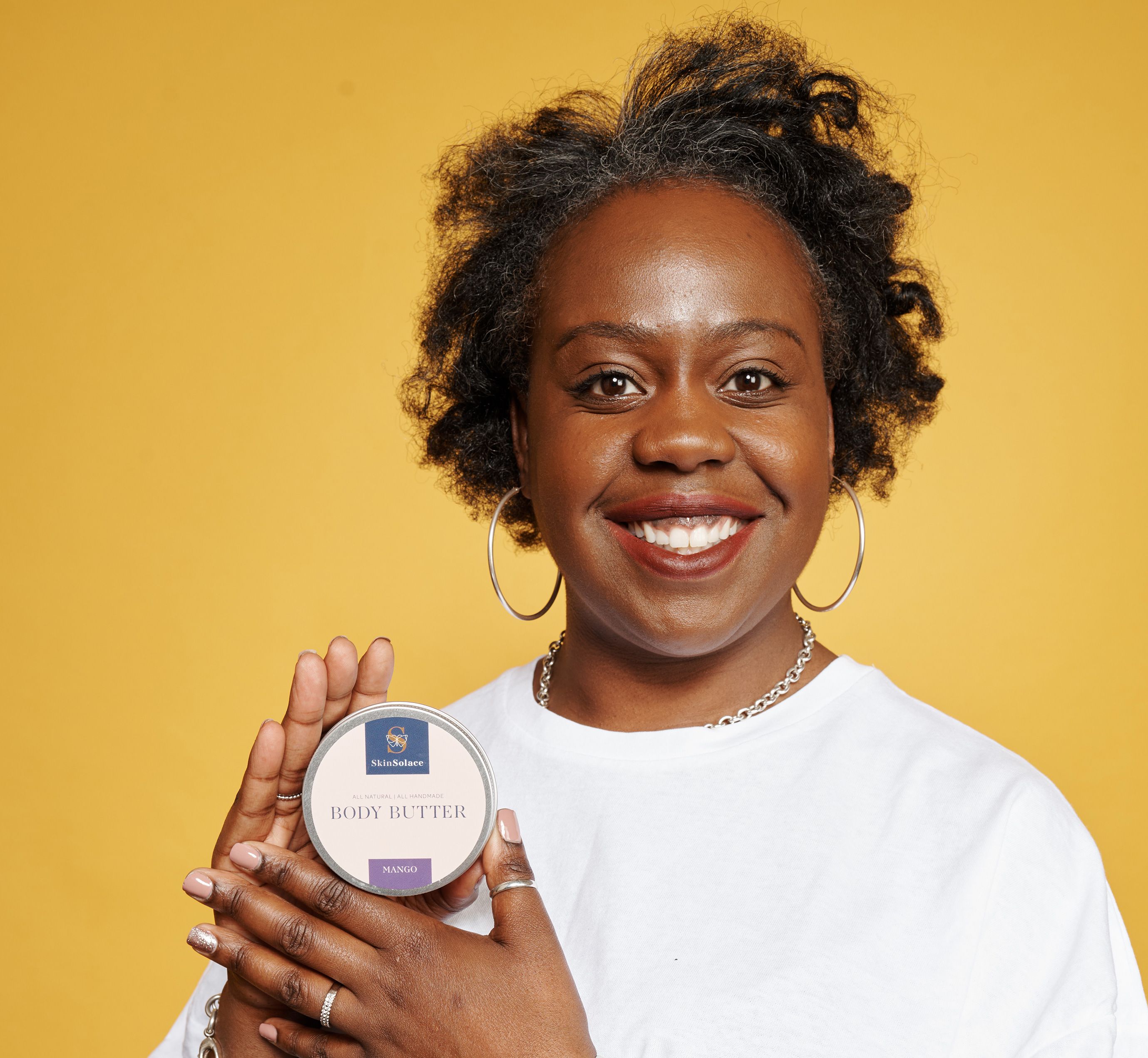 Natalee Onyeche holding a tub of Skin Solace.