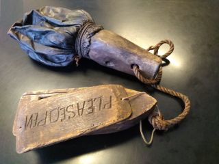 A small wooden boat with an attached label