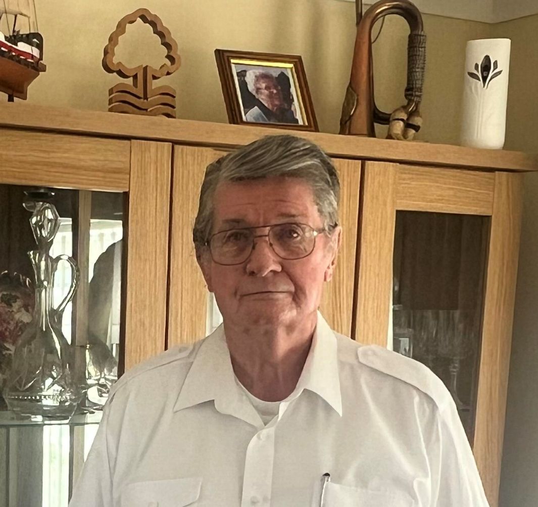 Neil Rose stands next to the portrait of his mother at his home near Tewkesbury, Worcestershire.