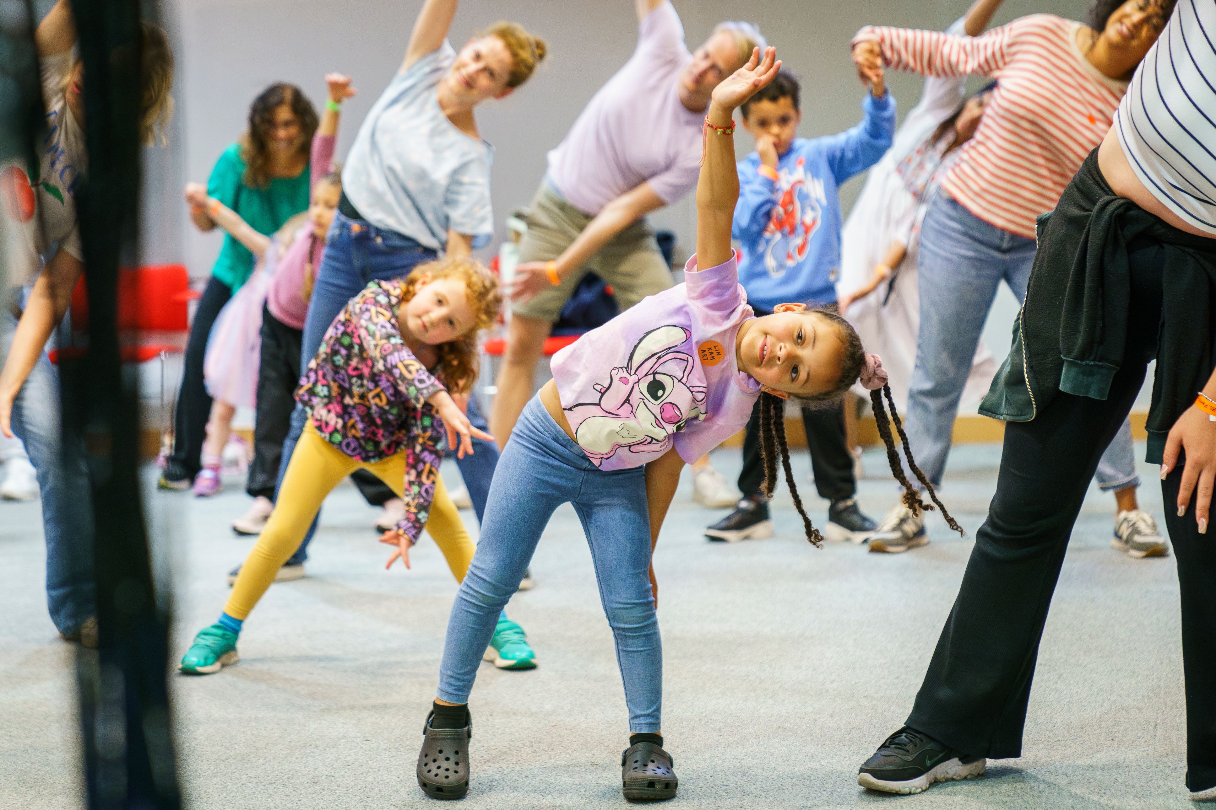 Children and families stretch at a learning event at the British Library.