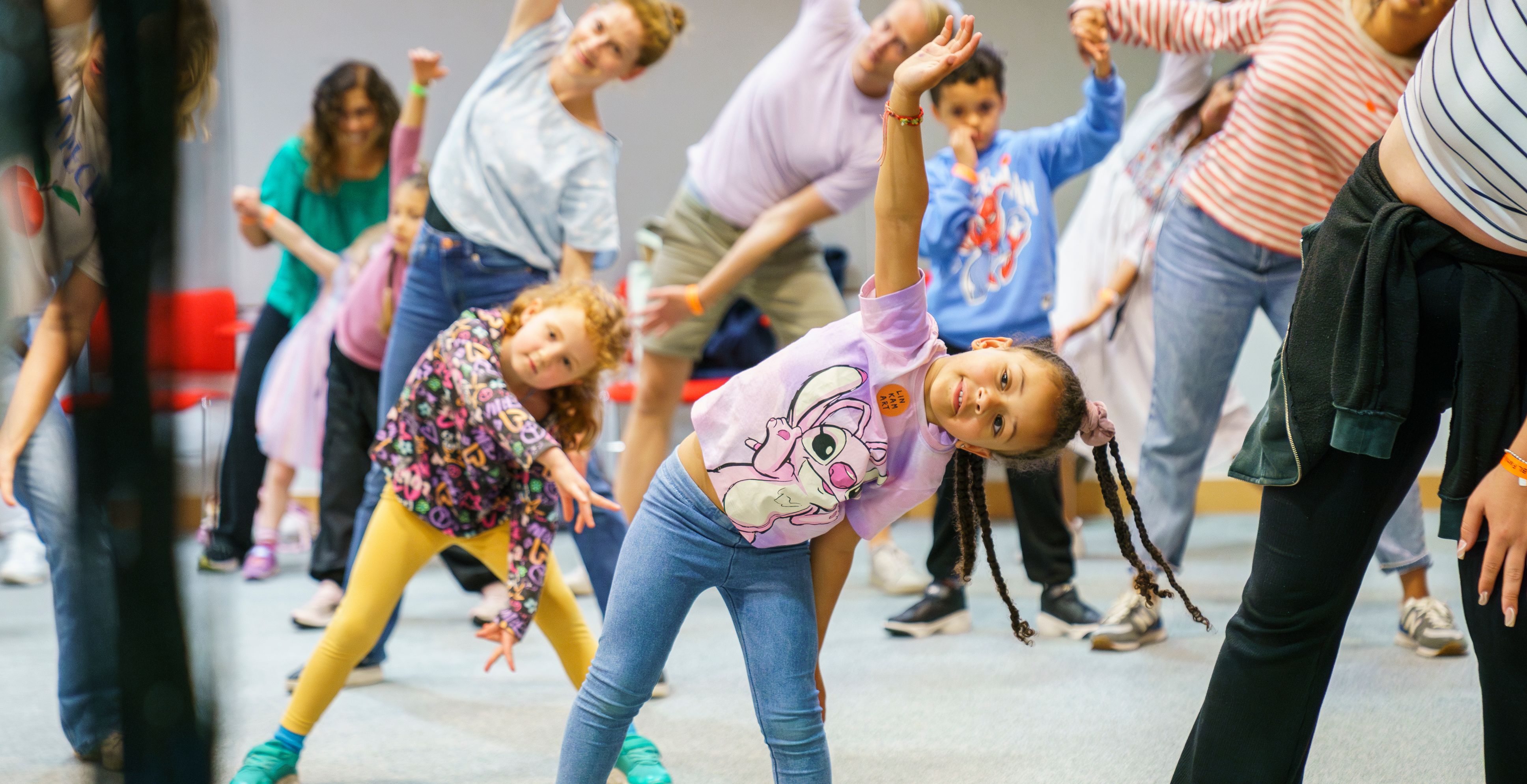 Children and families stretch at a learning event at the British Library.