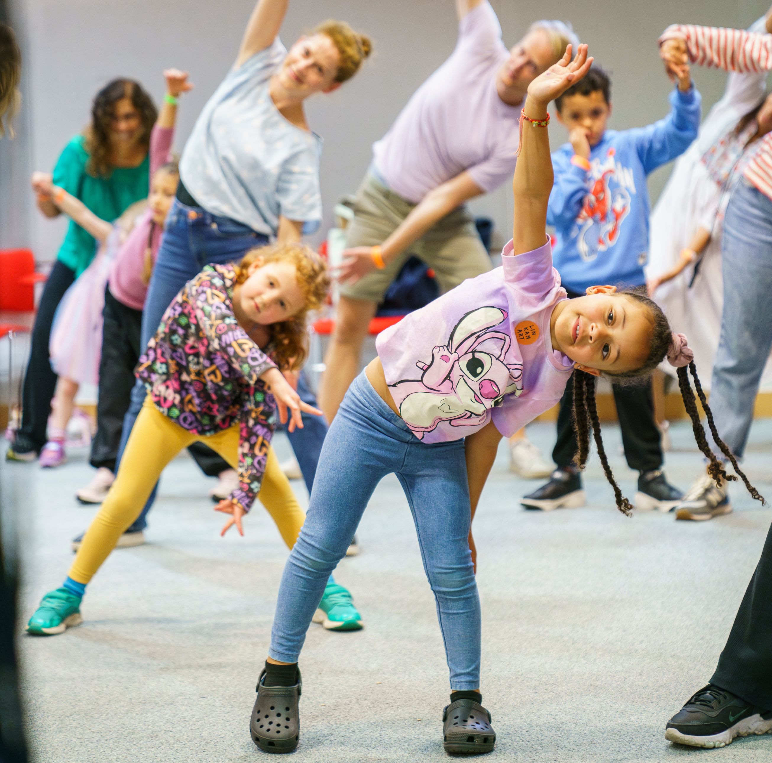 Children and families stretch at a learning event at the British Library.