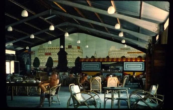 Soldiers relaxing topless in the NAAFI bar, freshly decorated and with a new mural depicting the London cityscape on the back wall.