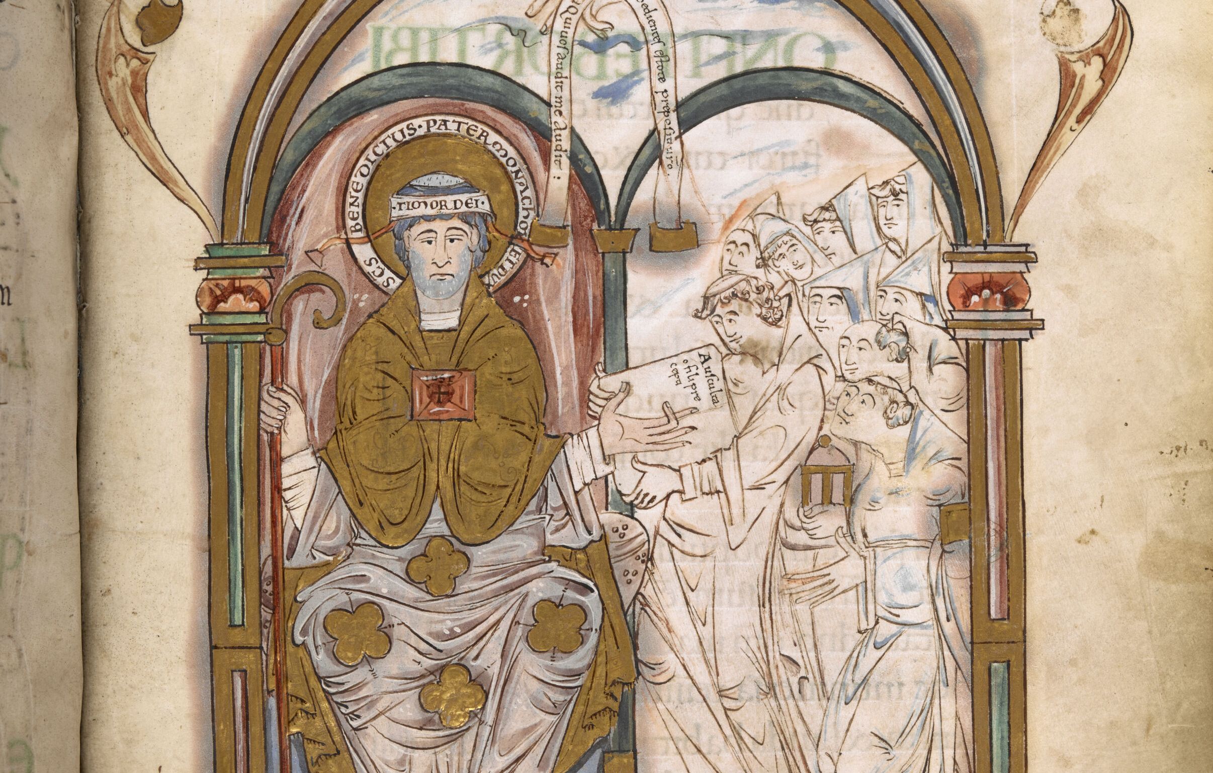 A page from the Eadui Psalter showing St Benedict giving the Rule to the monks. Framed by an arch, St Benedict is seated, while monks approach with an open book. The scribe, Eadui Basan, kneels embracing the saint's feet. Above, the hand of God appears holding an inscribed scroll.