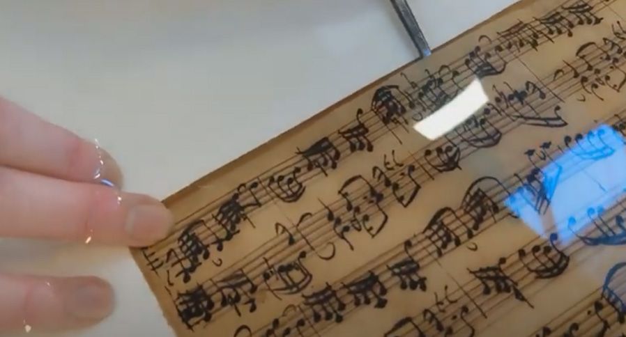 Removing the acidic paper inlay from Bach manuscript during aqueous treatment.