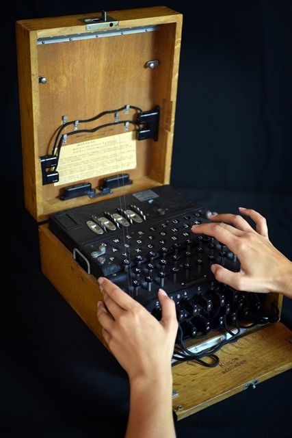 An original Enigma machine in its wooden case