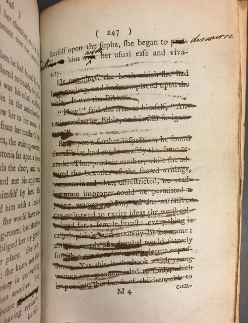 A page from a printed book, many lines have been crossed out by hand.