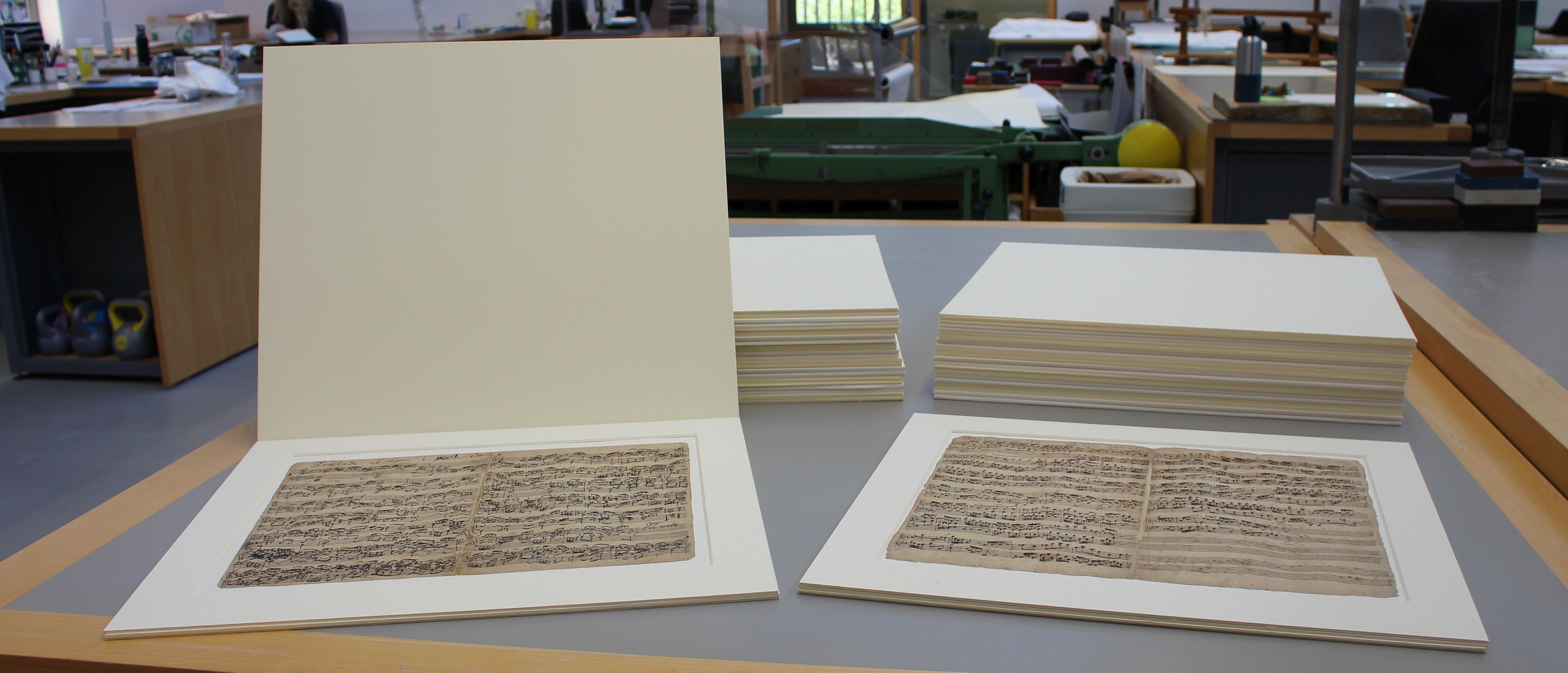 The new card mounts for each folio, with protective flaps at the front in back to keep the manuscripts safe in storage.