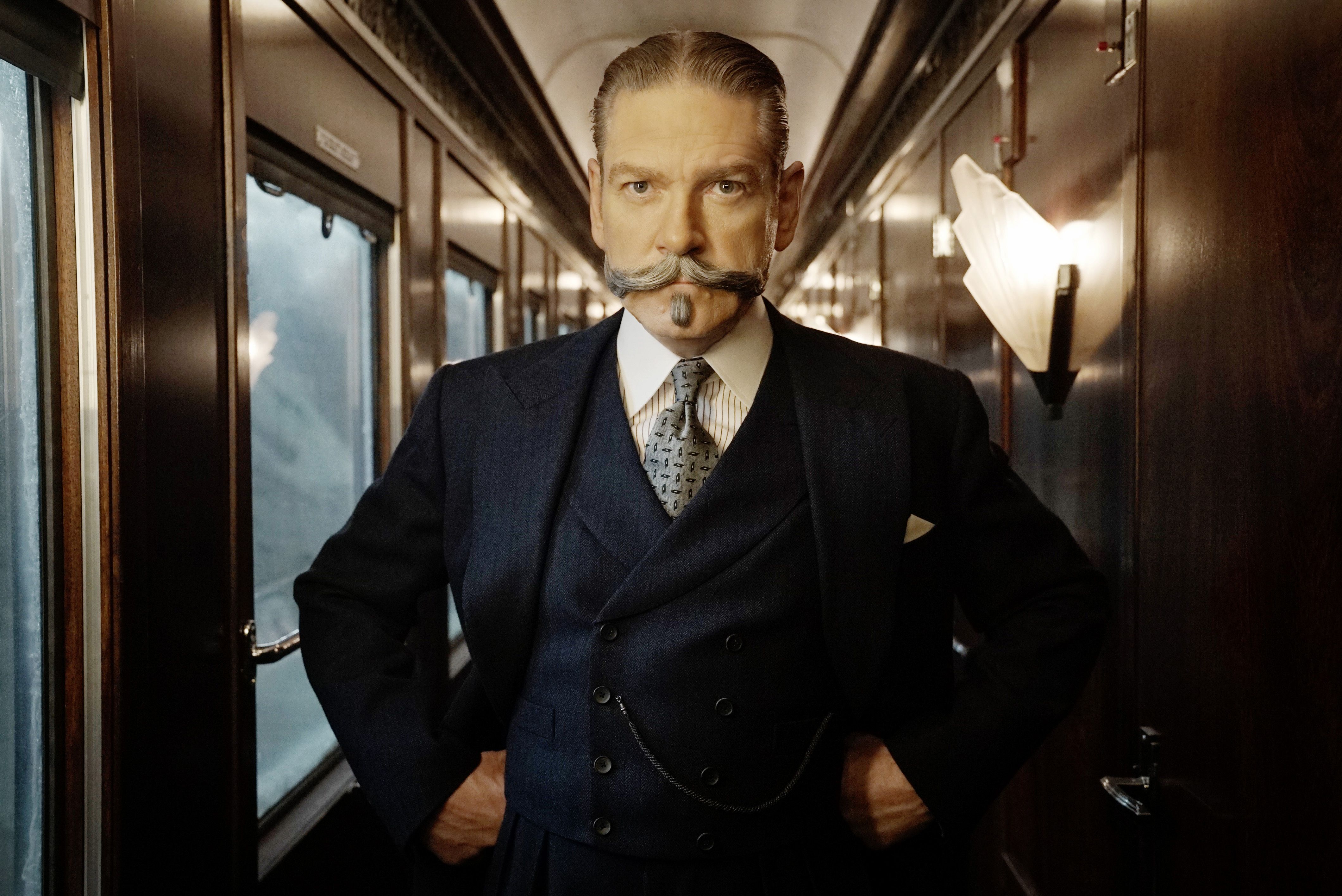 Kenneth Branagh as Hercule Poirot on a train.