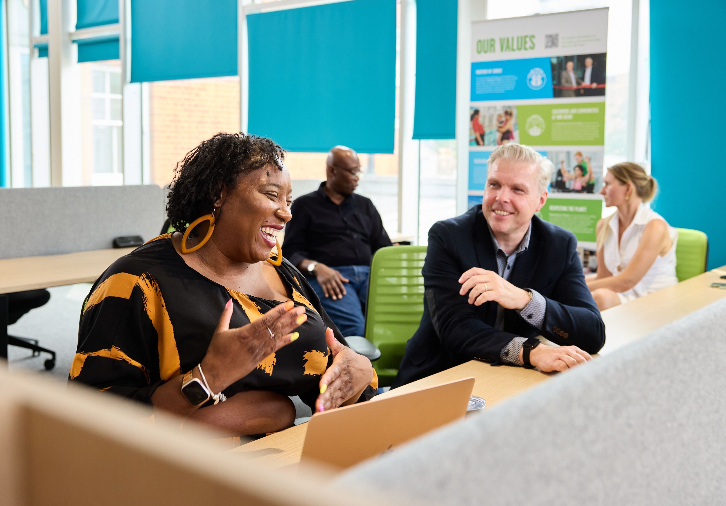 Man advising and woman at a business workshop.