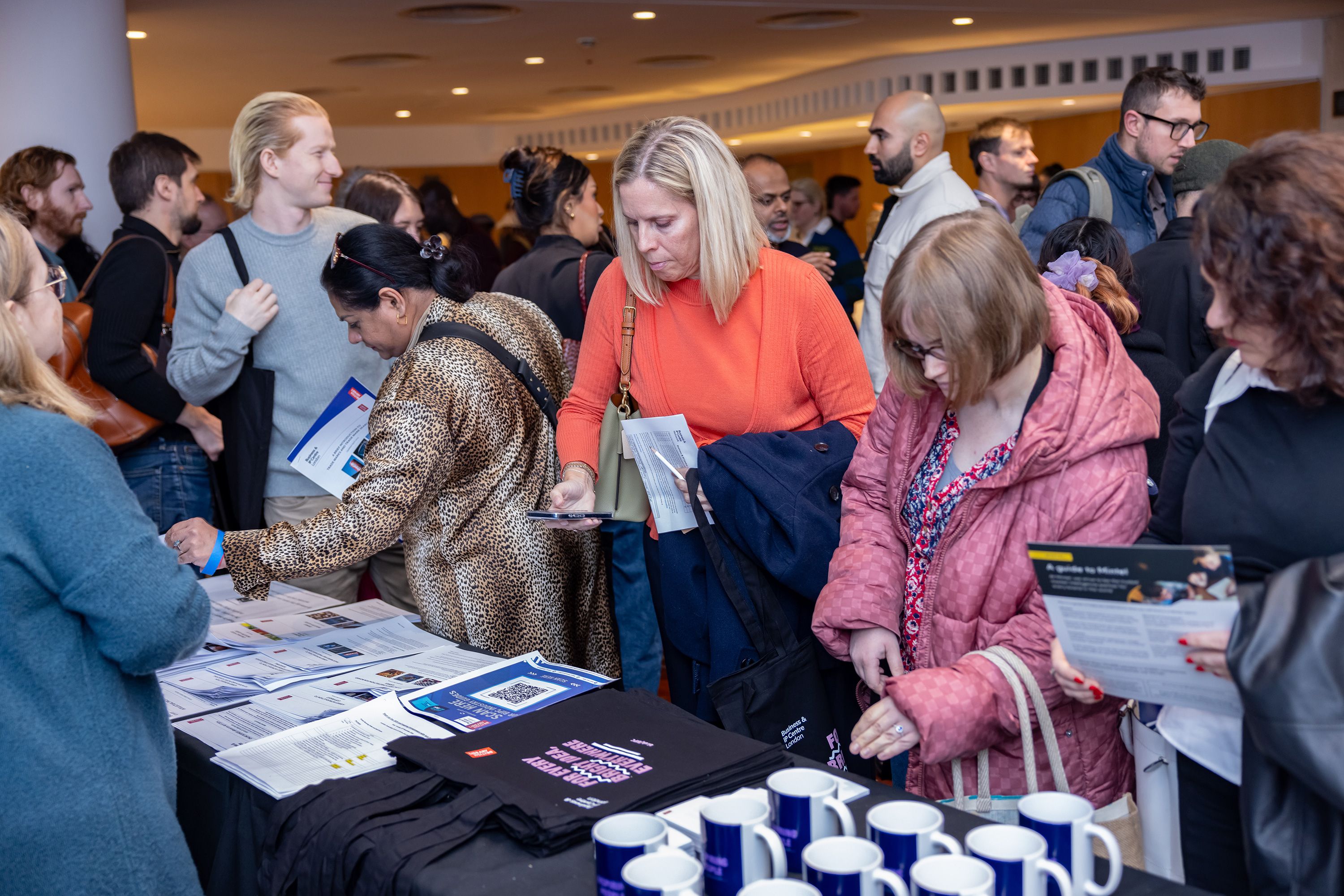 Event attendees at merchandise stalls.