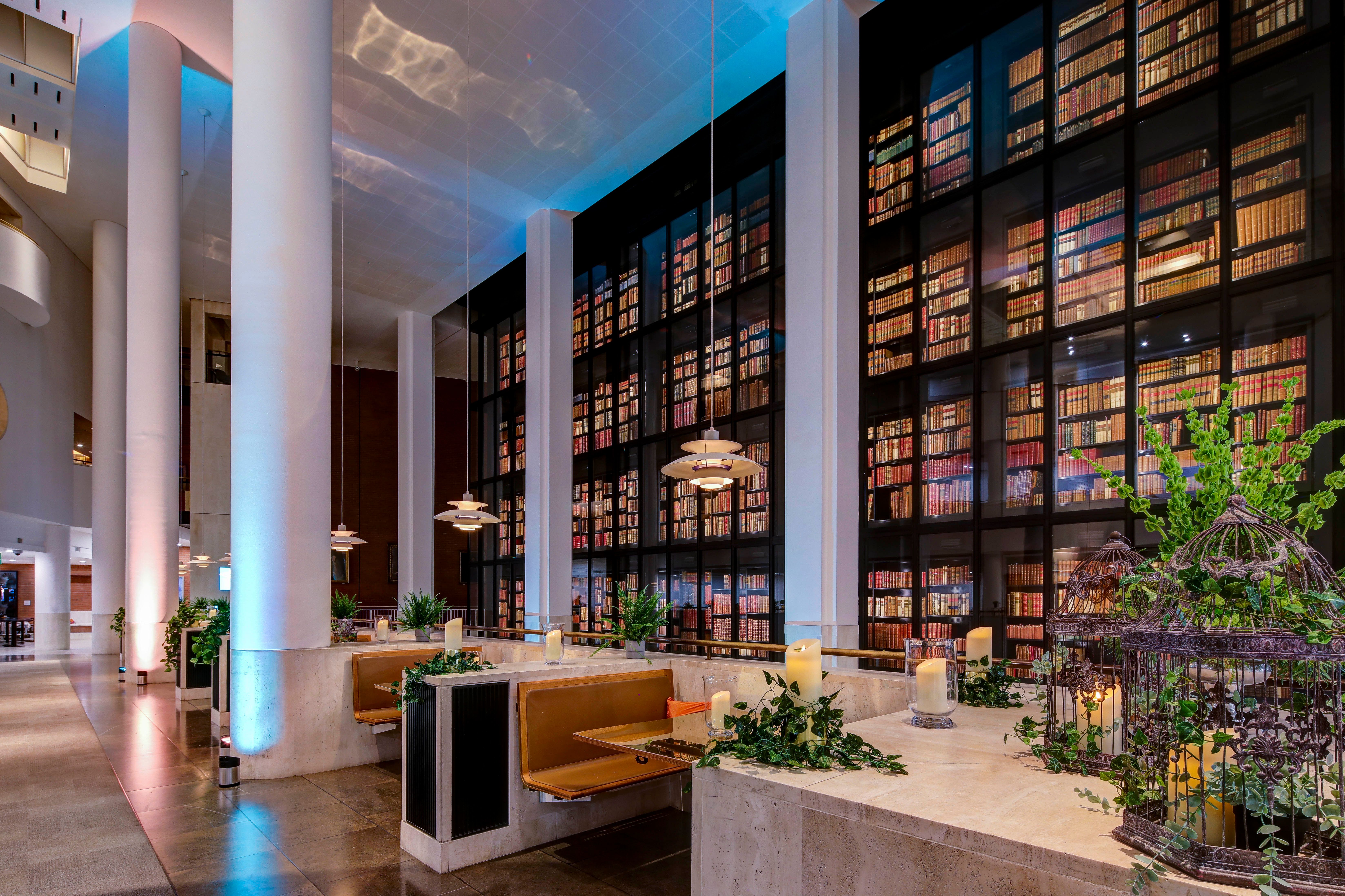Side view of the King's Library with rows of books behind glass, going up to the ceiling.