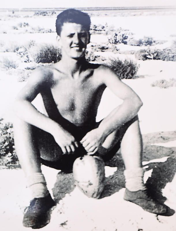 Ken McGinley sitting down with a coconut on Christmas Island.