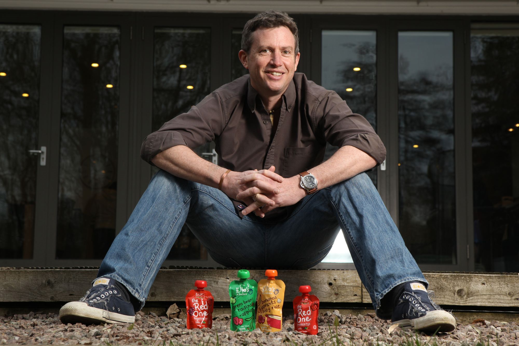 Paul Lindley sitting with his products.