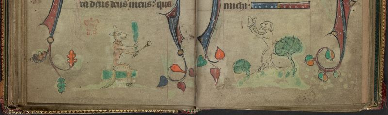 An opening from a Book of Hours, featuring a marginal illustration of a fox teaching a dog.
