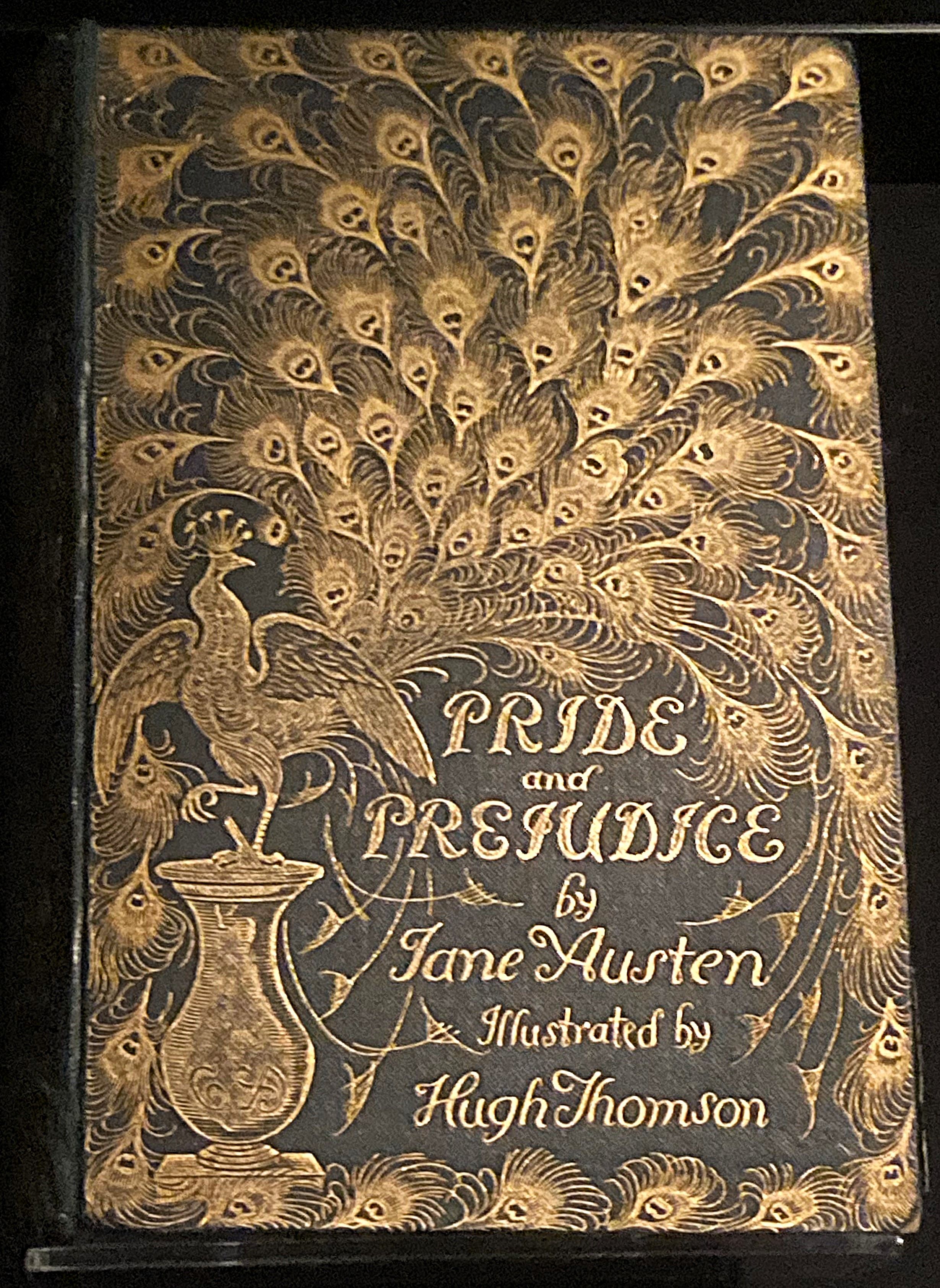 Front cover of an edition of Pride and Prejudice. The cover is deep green and is dominated by a large gilt picture of a peacock with its tail fanned out.