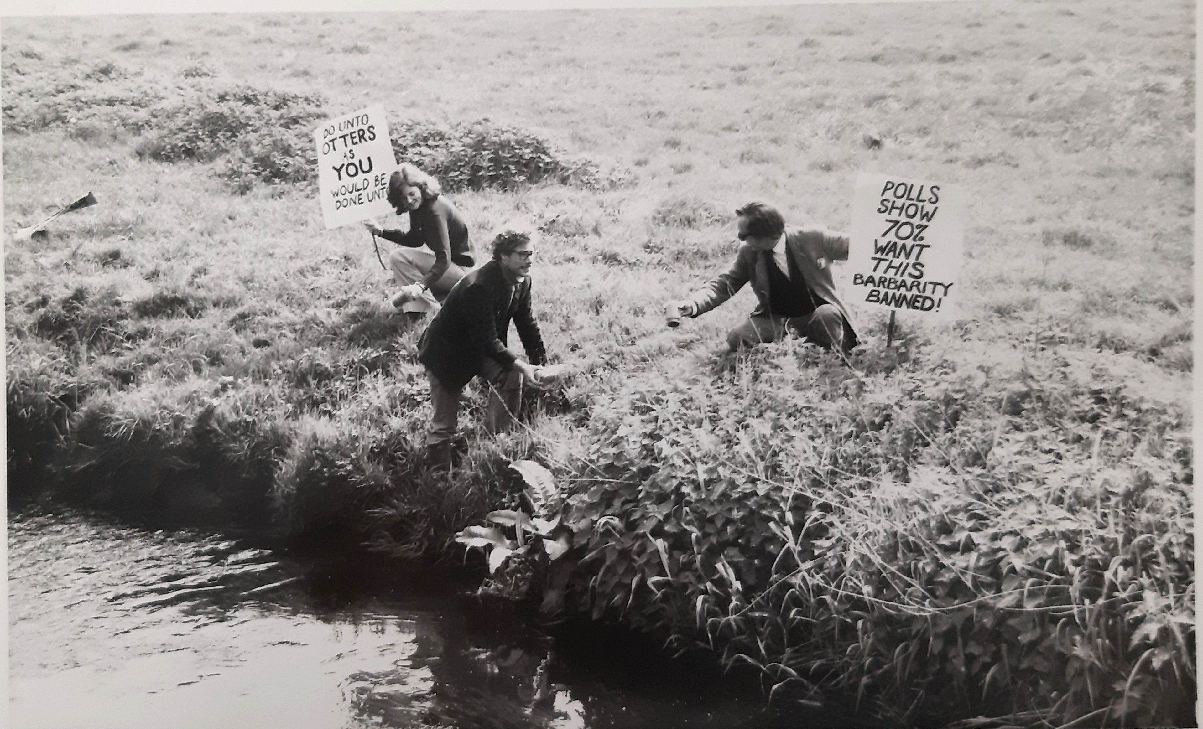Ryder (far right) and friends protesting otter-hunting, holding signs.