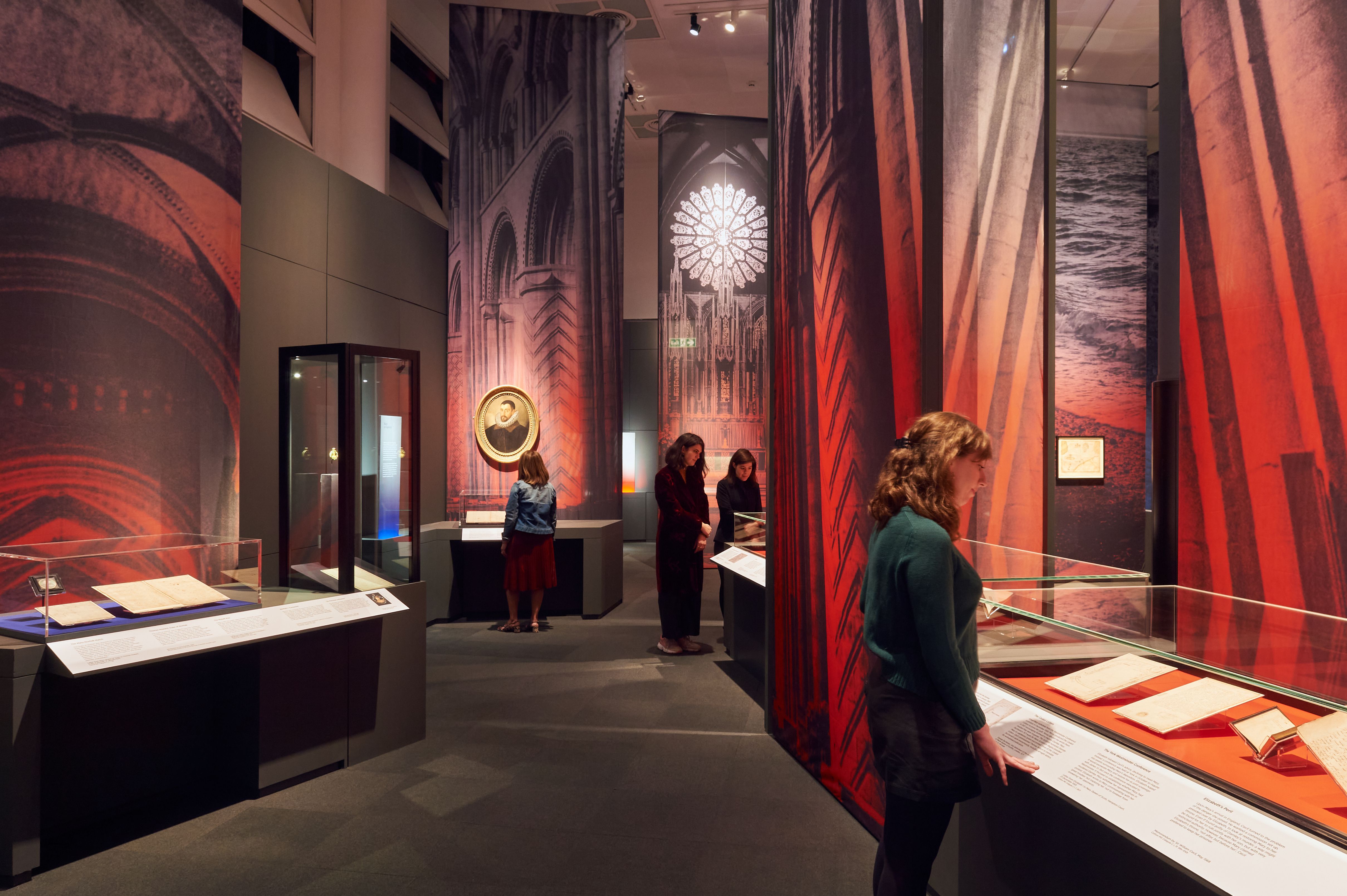 Visitors looking at items in display cabinets.