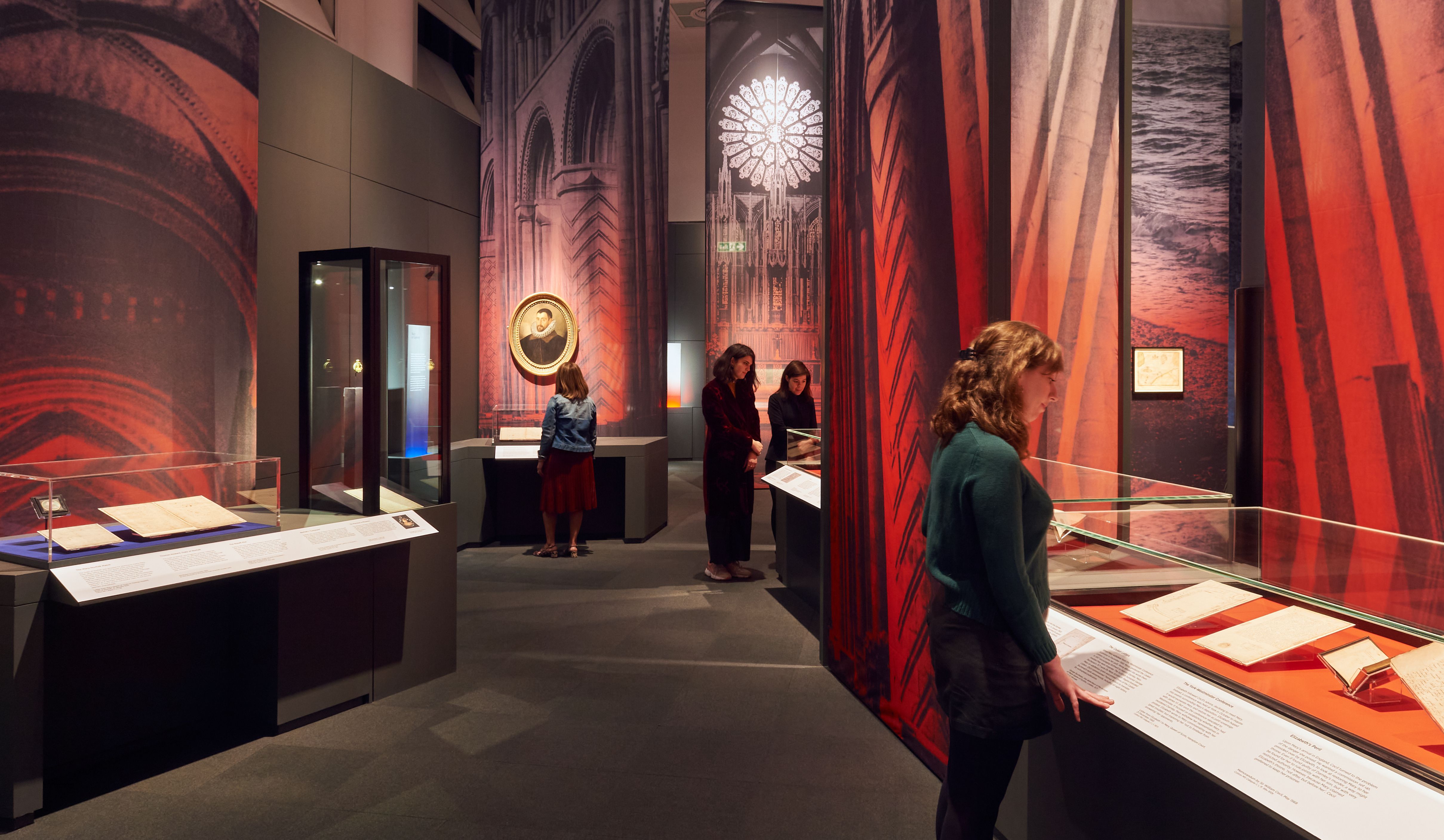 Visitors looking at items in display cabinets.