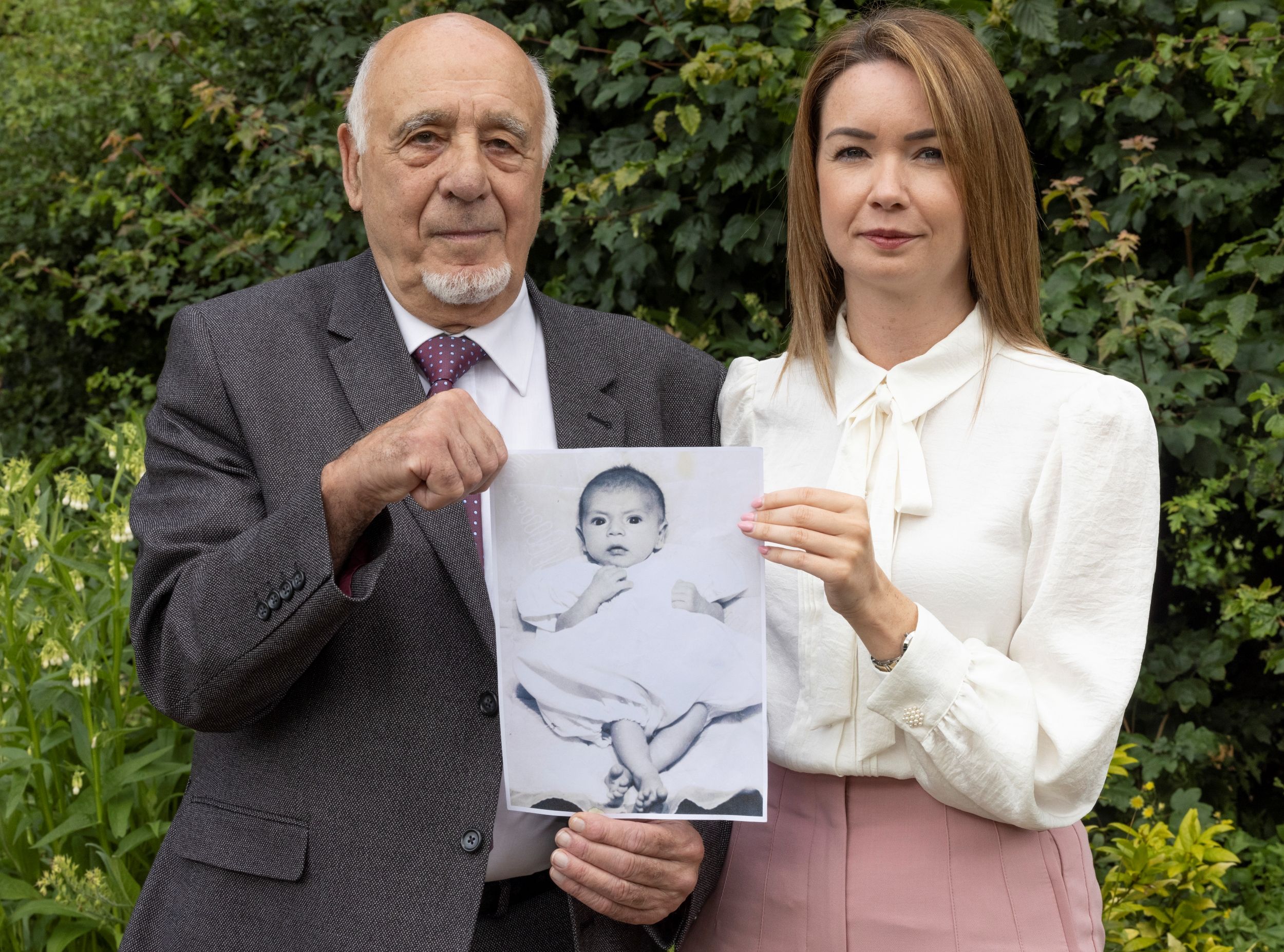John Morris and his daughter, Laura, hold up a photo of John's baby boy