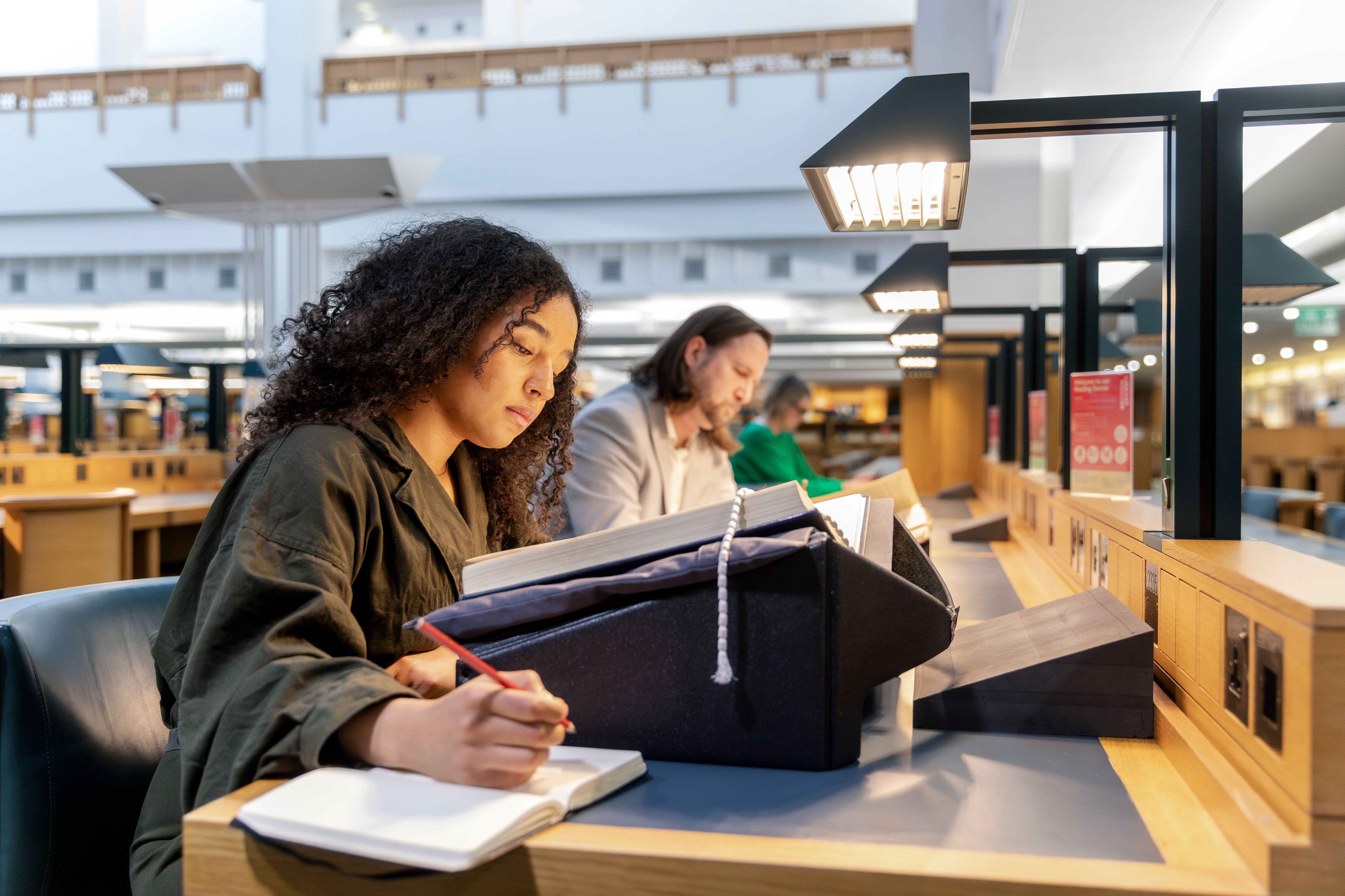 Person consulting a collection item in a British Library Reading Room