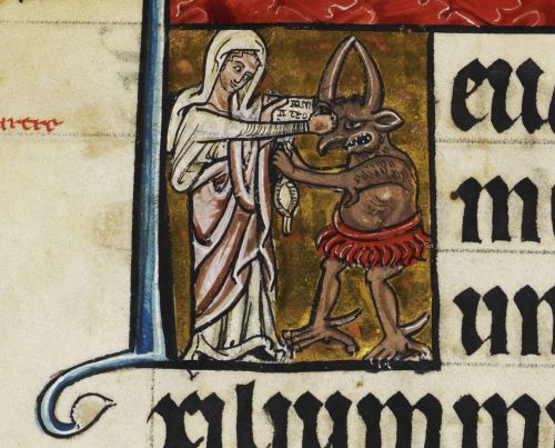 A women in white whites punches a horned beast between the eyes