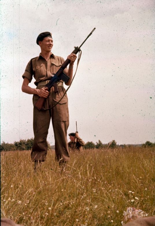 Frank Bools in uniform with a military beret and a rifle.